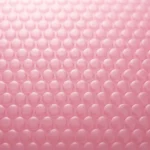 Close-up of pink anti-static PE bubble film surface — dissipative range ESD packaging material with integrated bubble cushioning layer