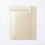 Light champagne pearlescent bubble mailer bag — matte satin PE outer film with large dome-shaped air bubbles, self-seal closure, custom colors for cosmetics and gift packaging